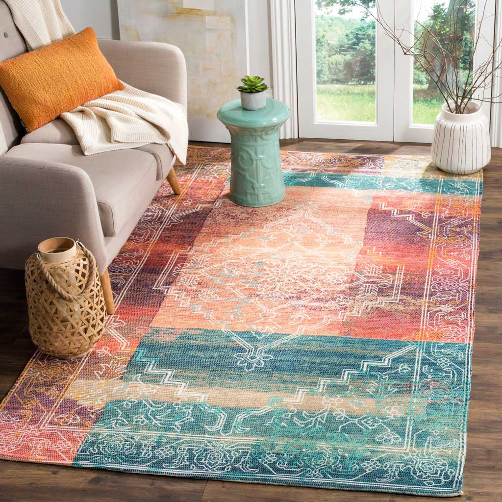 A coral and aqua rug brings a vivid medallion design and ornate borders to the living room.