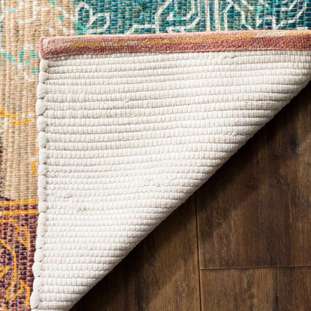 A folded corner reveals the rug's pale woven backing and bound edge.