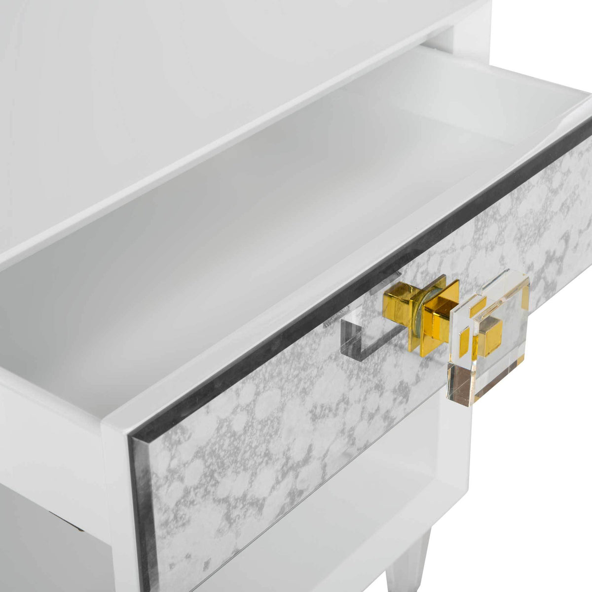 A white drawer slides out from an antiqued mirror front with a clear, brass-accented pull.