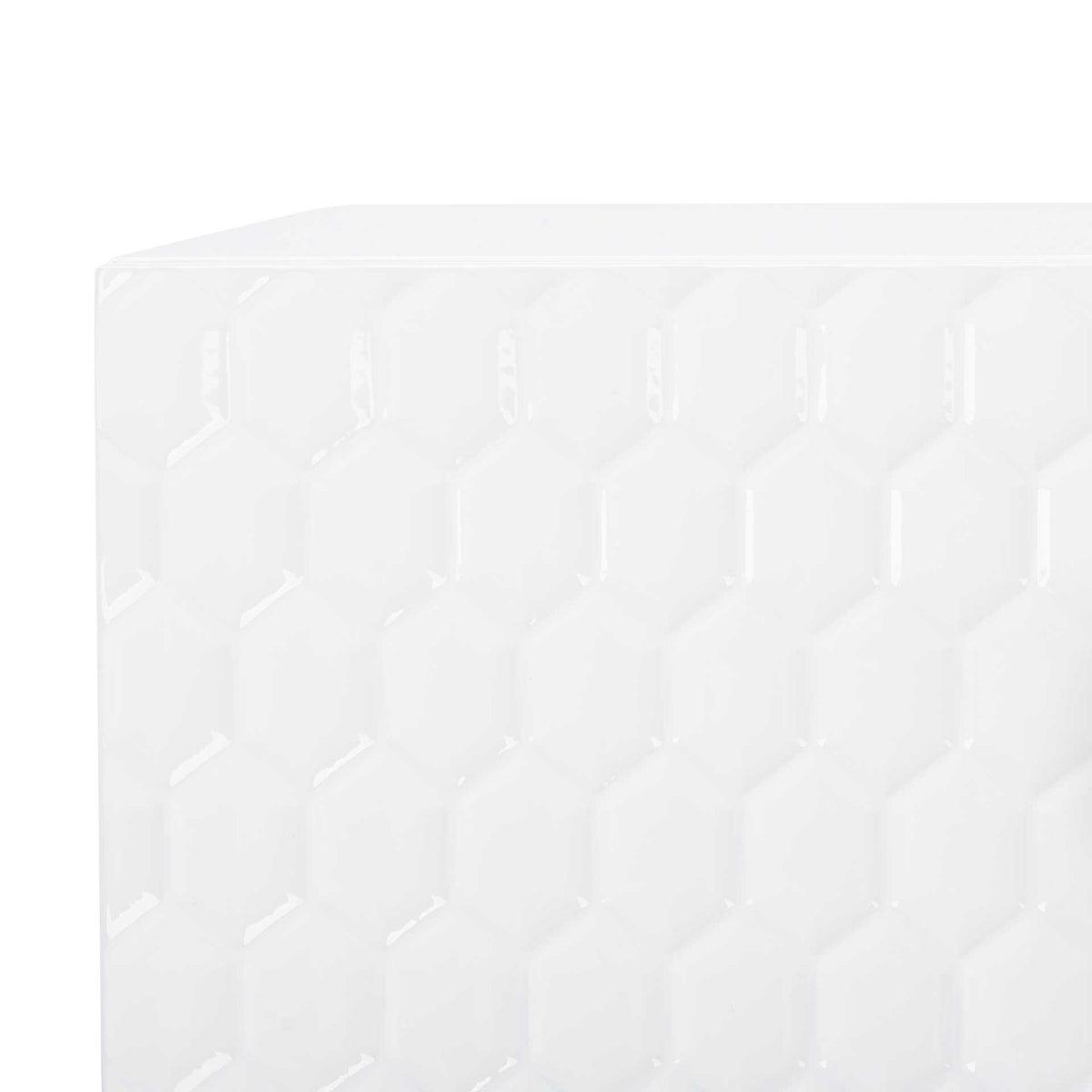 Glossy white hexagonal relief creates dimensional texture across the table's drawer front.