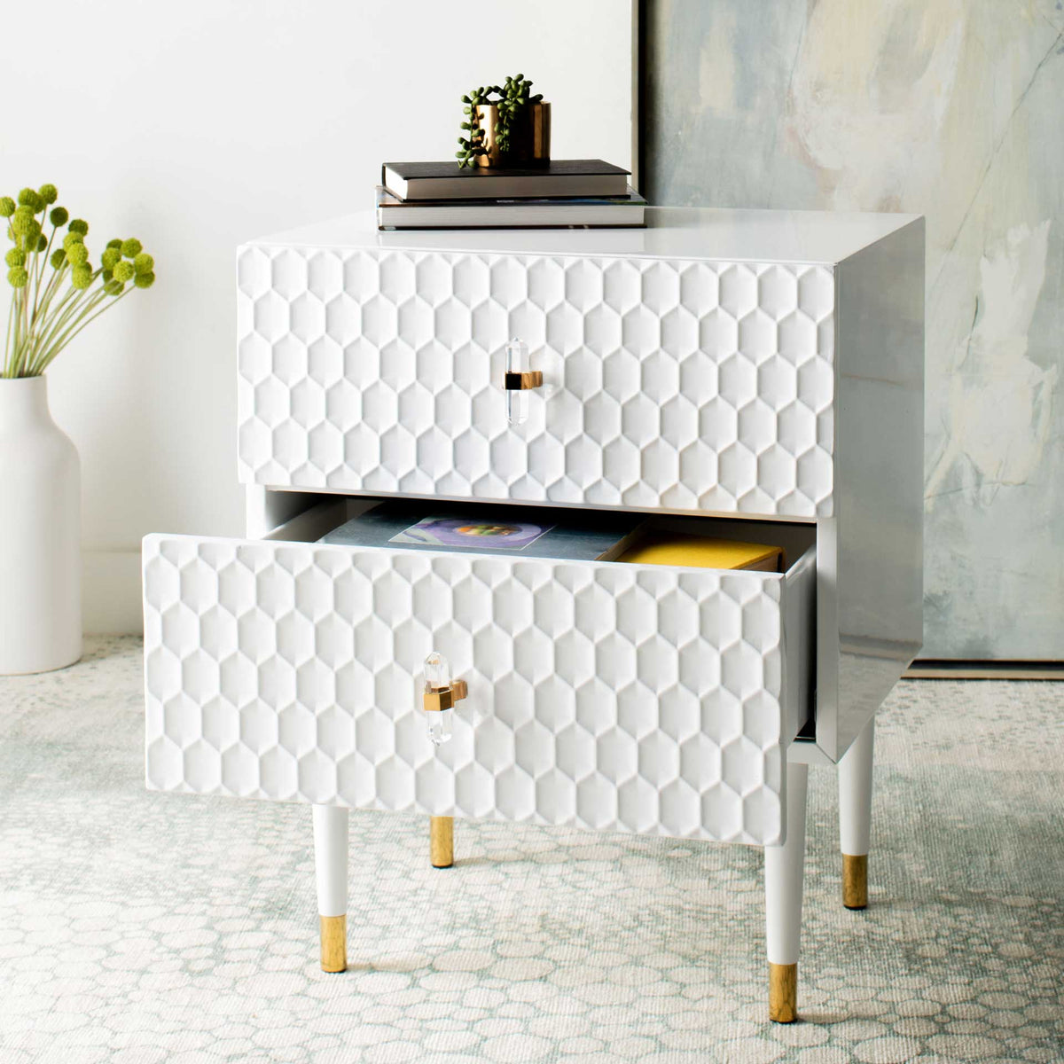 The open lower drawer provides handy storage below the raised honeycomb front of the white side table.