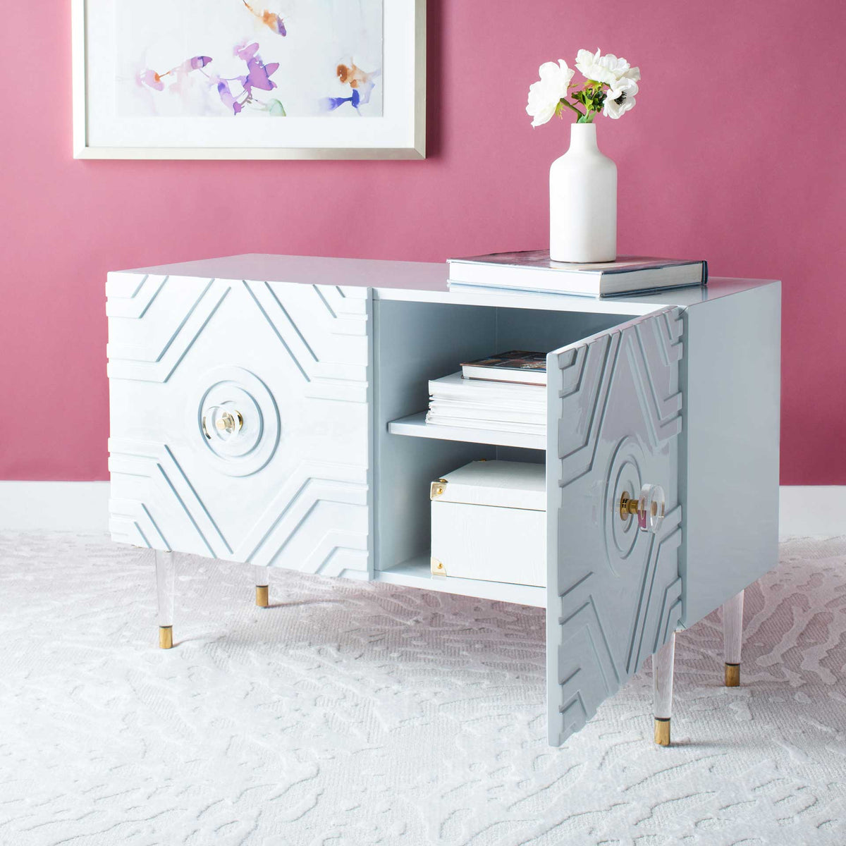 A raised diamond-pattern door opens to reveal roomy shelving above slender, gold-tipped legs