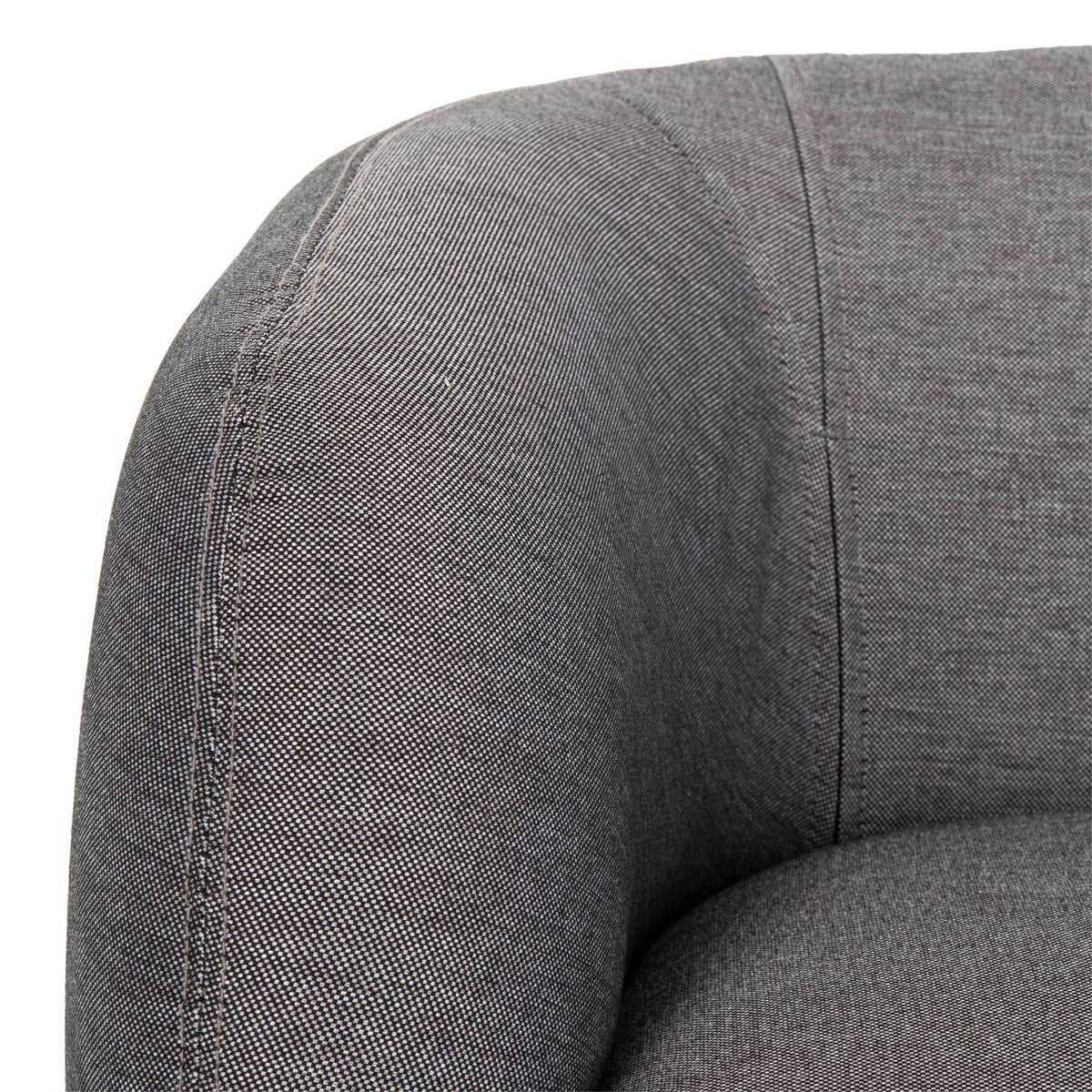 Fine gray woven fabric and neat seams highlight the loveseat's rounded arm.