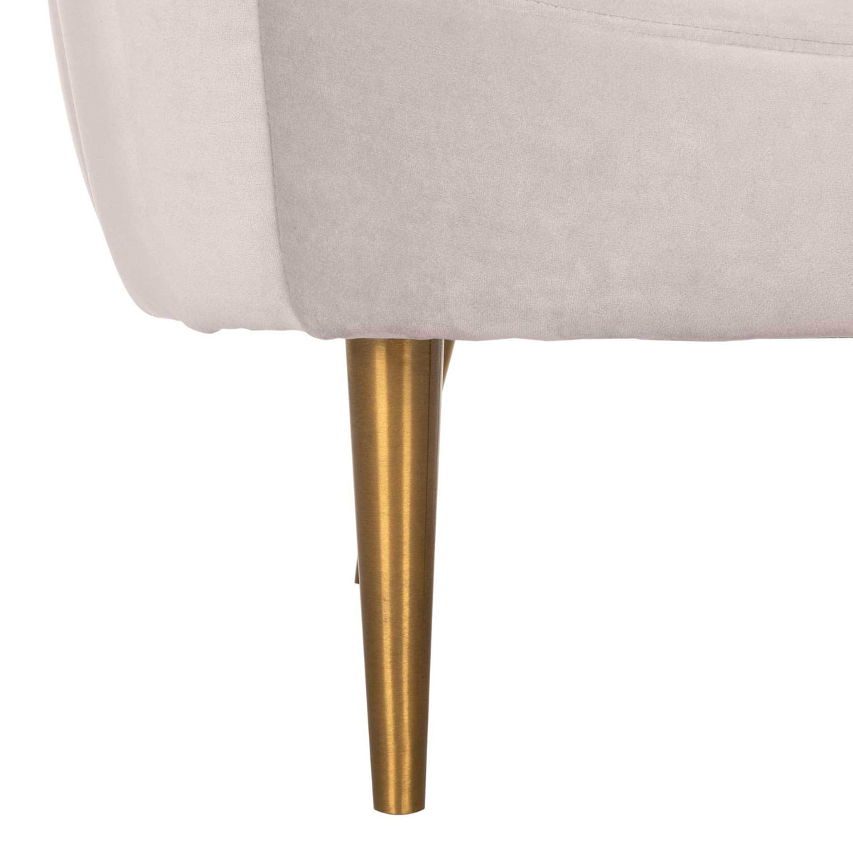 A slim, tapered gold metal leg supports the pale taupe velvet seat