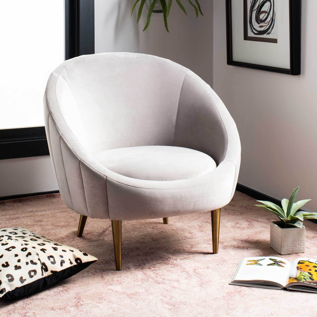 Soft pale taupe velvet and slim gold legs give the curved chair an inviting look