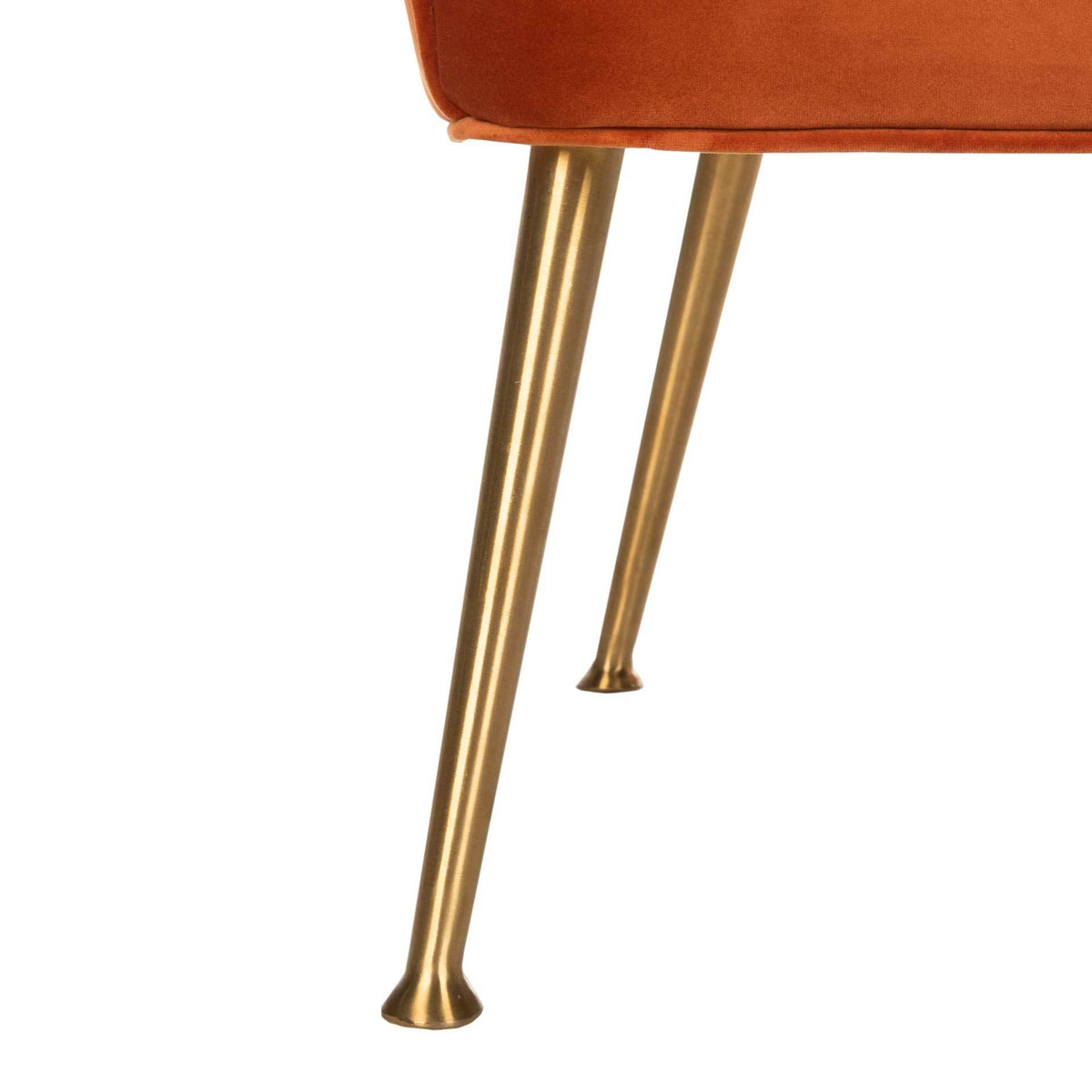 Slim, tapered gold metal legs end in subtly flared feet beneath the sienna velvet seat