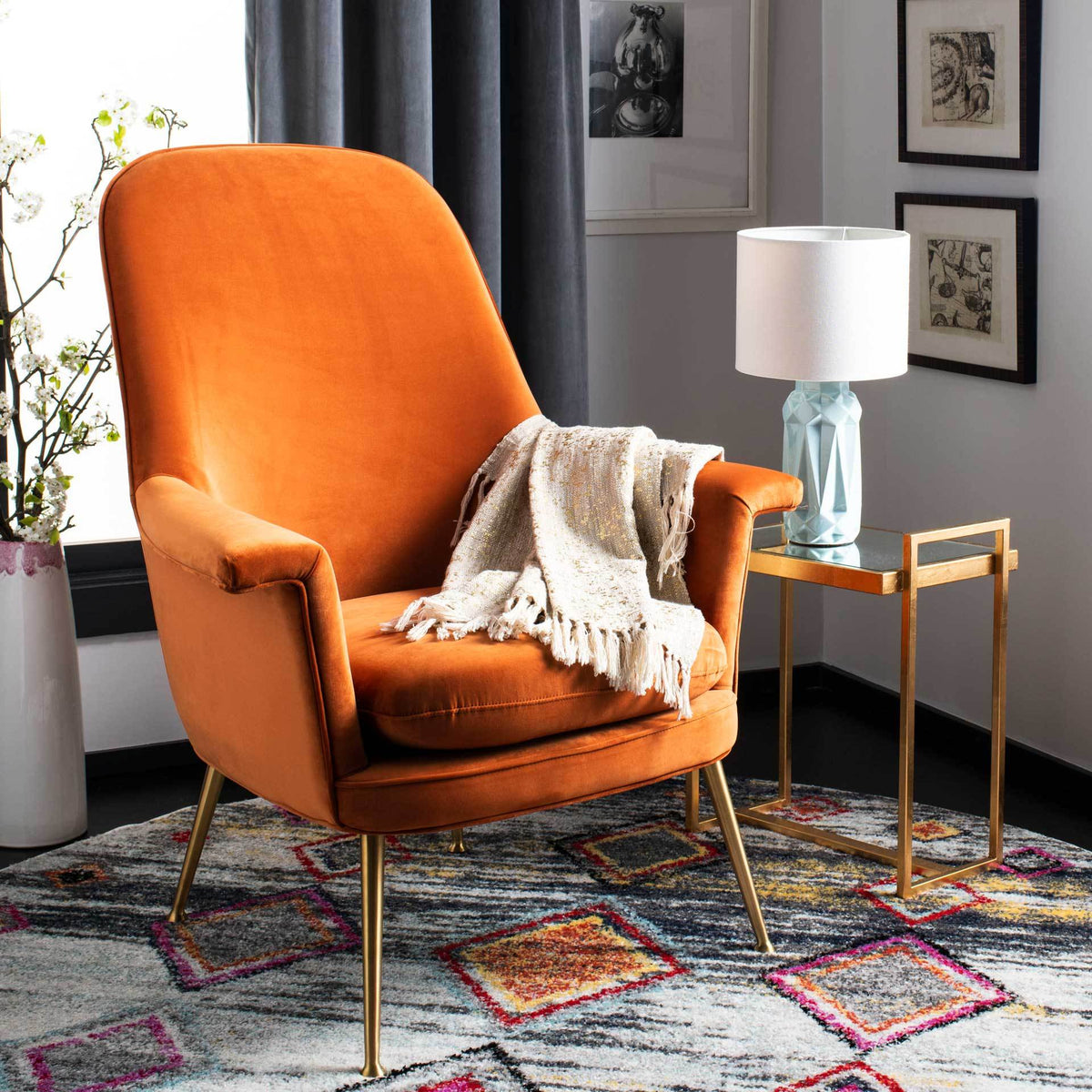 Rich sienna velvet and gold legs bring inviting warmth to a cozy seating area