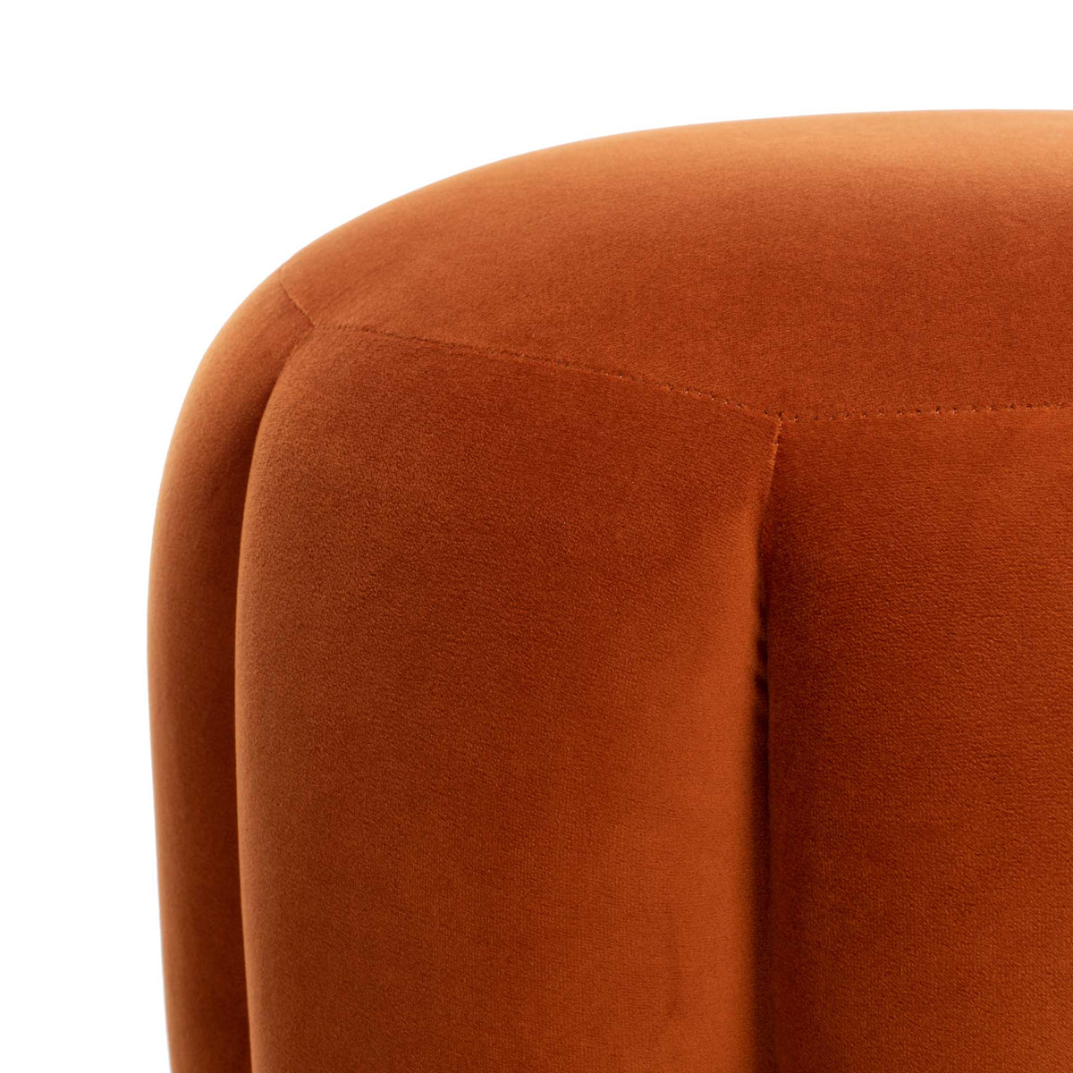 Soft sienna velvet reveals richly padded channels around the curved seat.