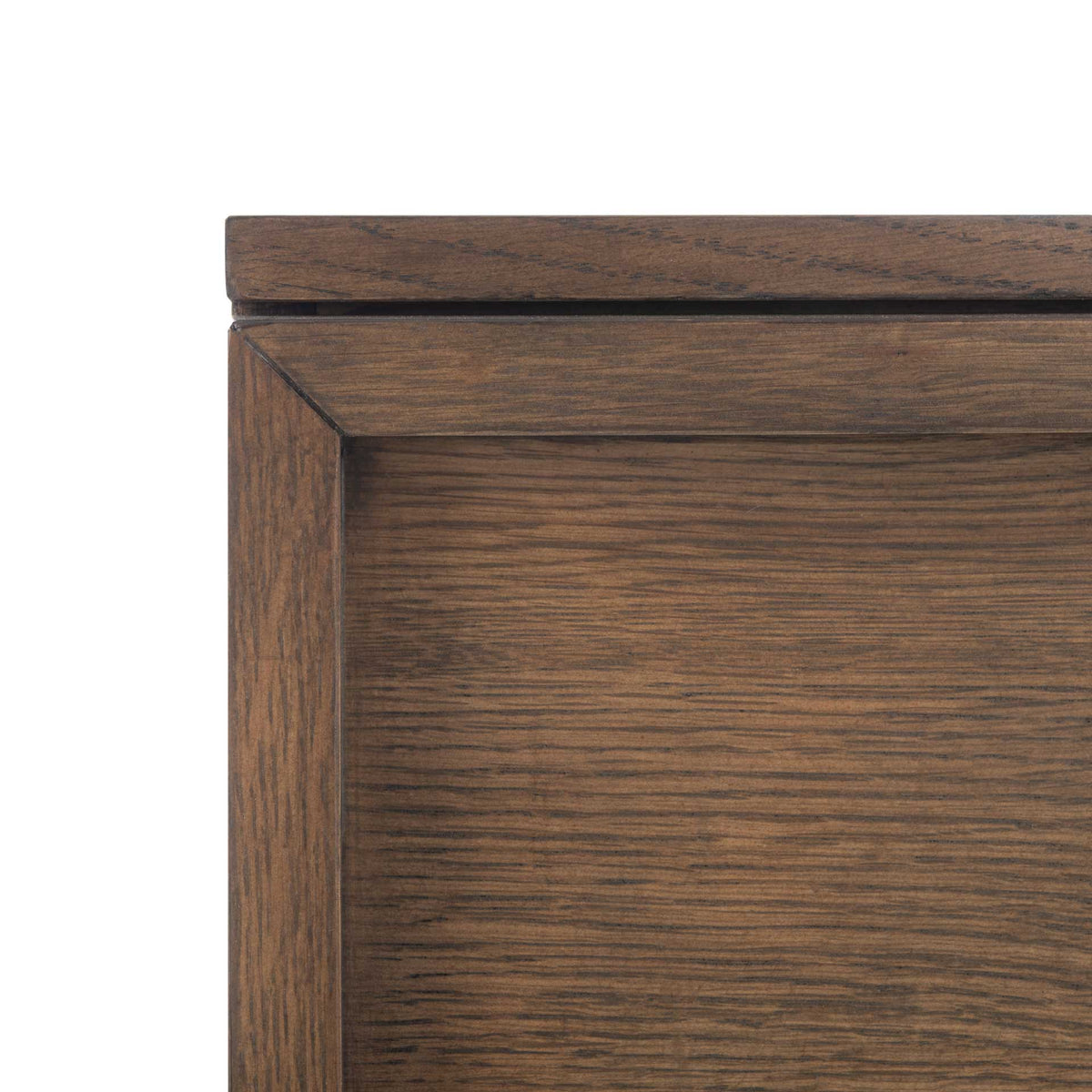 Mitered framing borders an inset drawer panel with warm, textured wood grain.