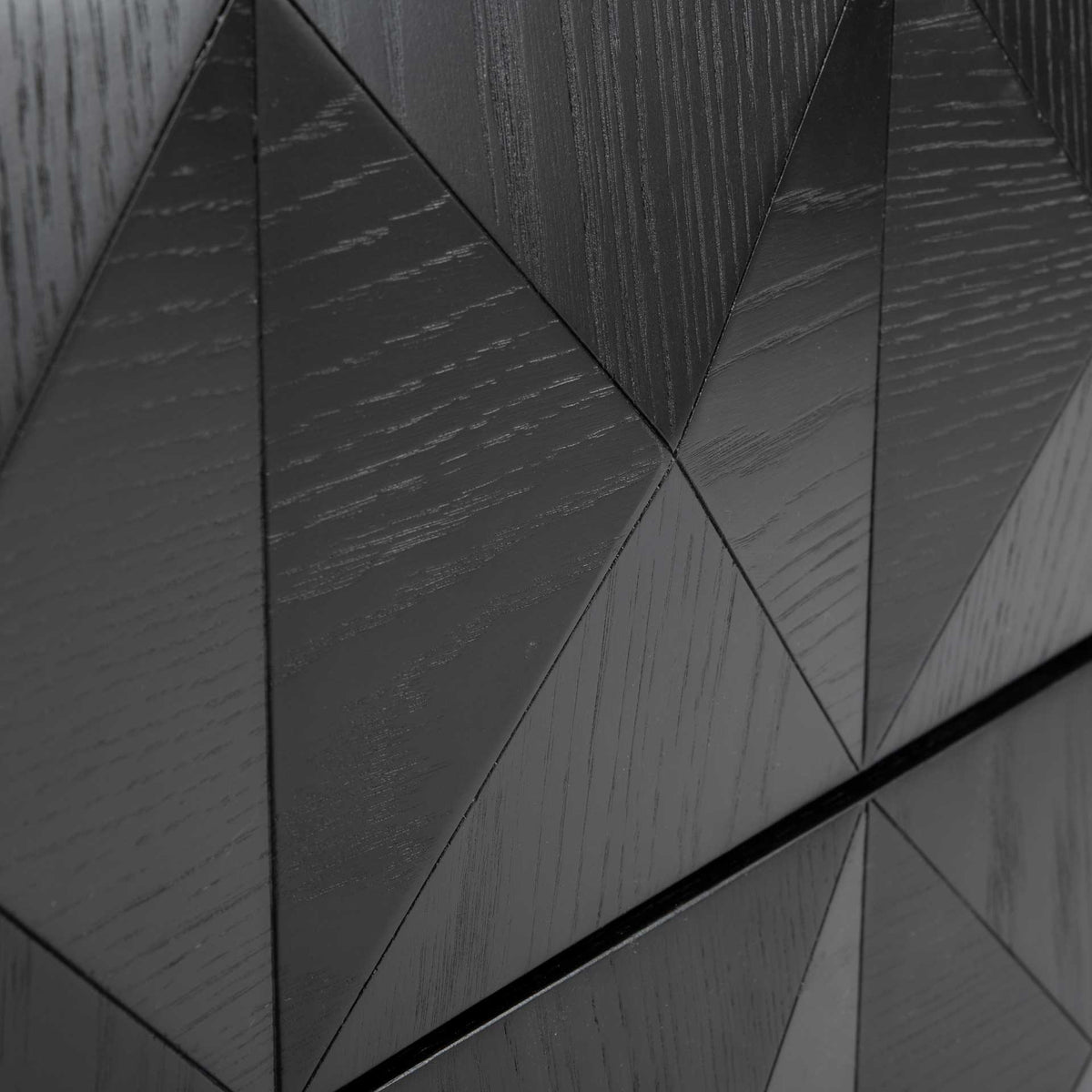 Dimensional triangular panels create a diamond pattern across the textured black drawer fronts