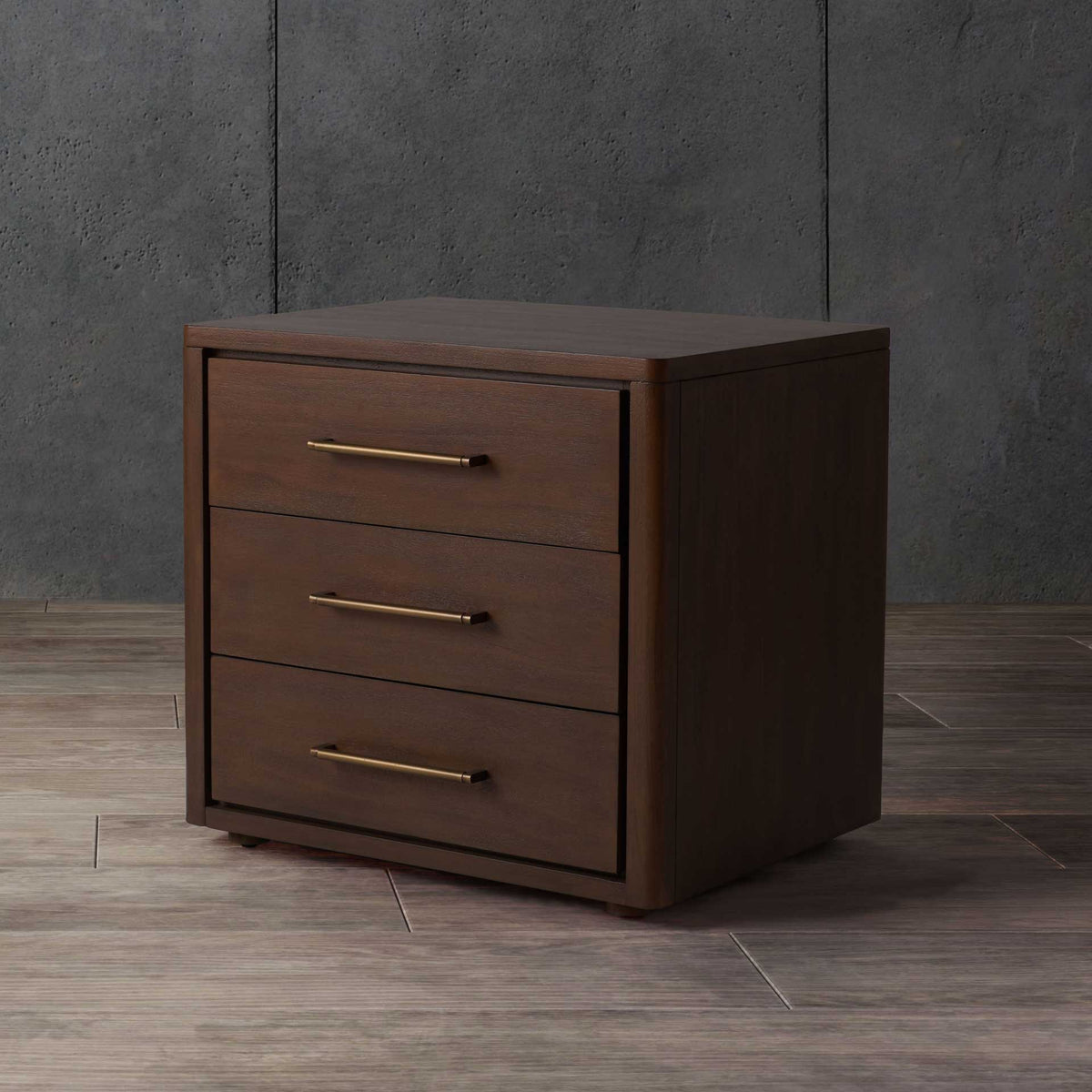 Warm brown finish and brass-tone pulls make this three-drawer nightstand a welcoming accent