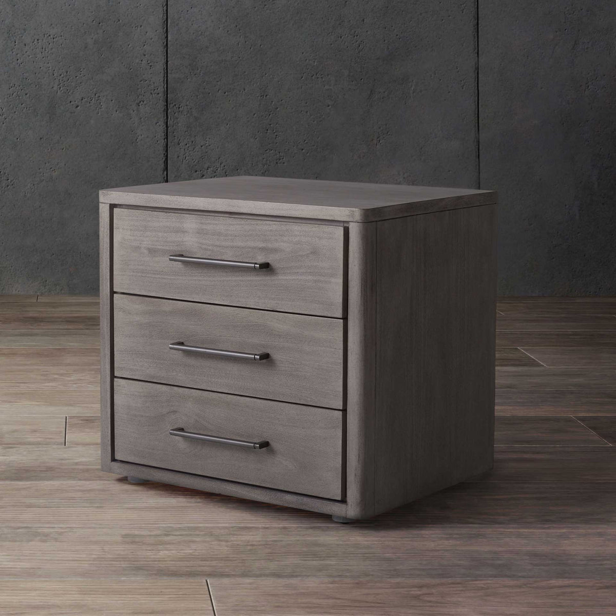 Light gray finish brightens this three-drawer nightstand with understated silver-tone pulls