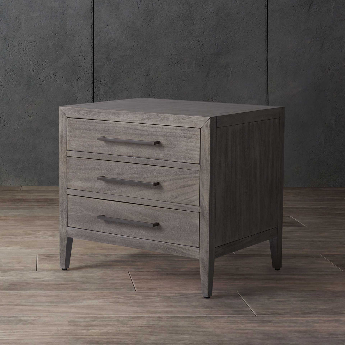 Soft light gray wood grain and three sleek pulls deliver calm, convenient bedside storage.