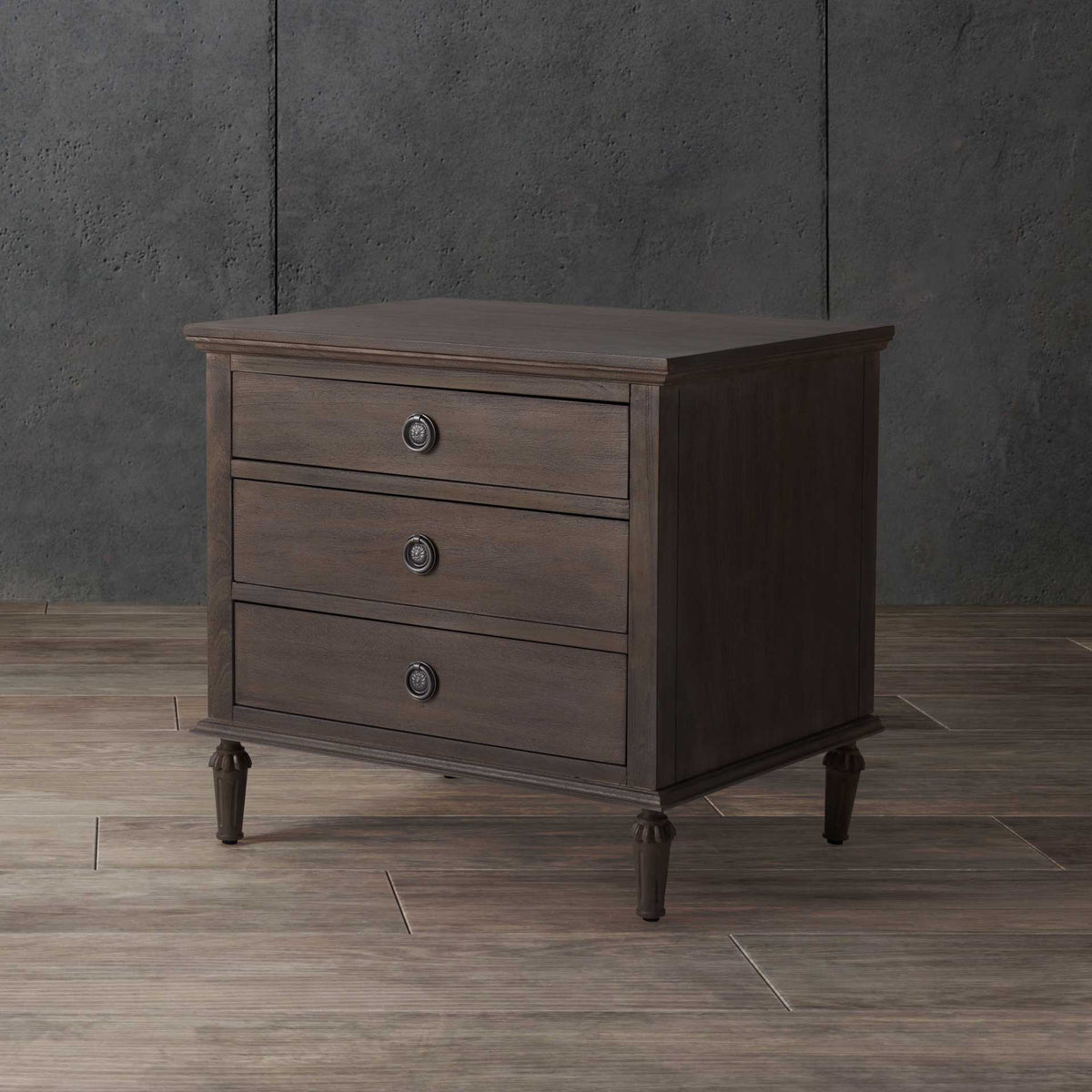 Three stacked drawers and cool silver-tone pulls add functional charm to this light brown nightstand.