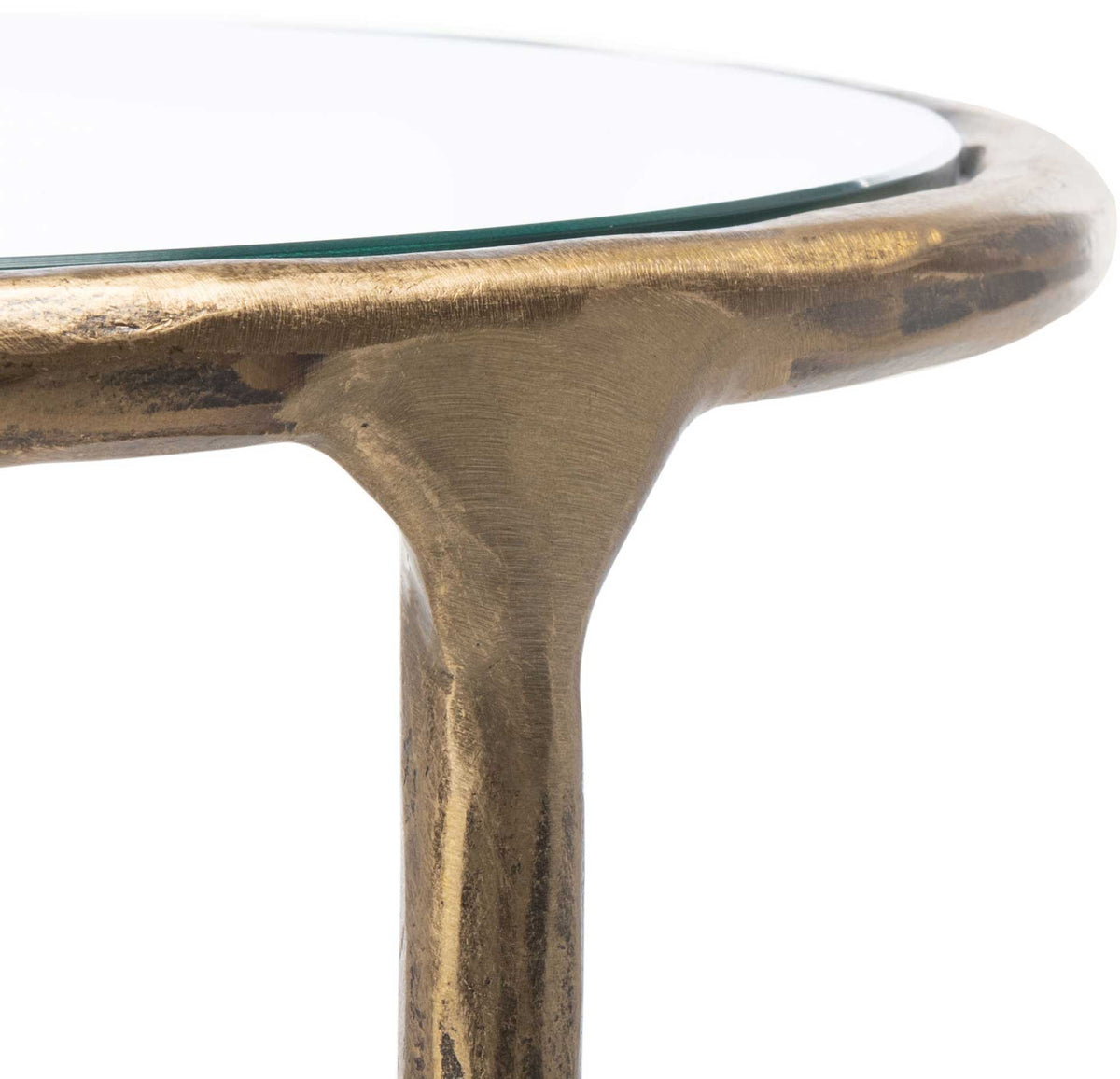 A sculpted brass-toned rim frames the glass top and curves into a slender metal leg.