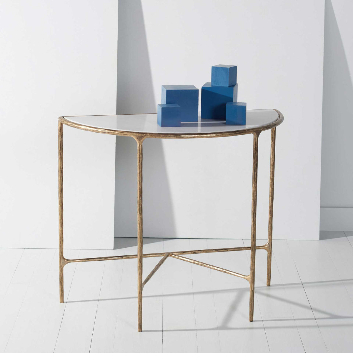 A white marble top and brass-finished frame create an elegant display surface