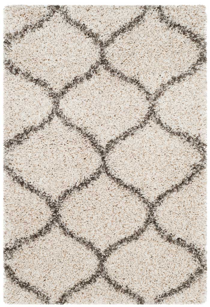 Compact ivory shag accent rug crossed by gray curved lines