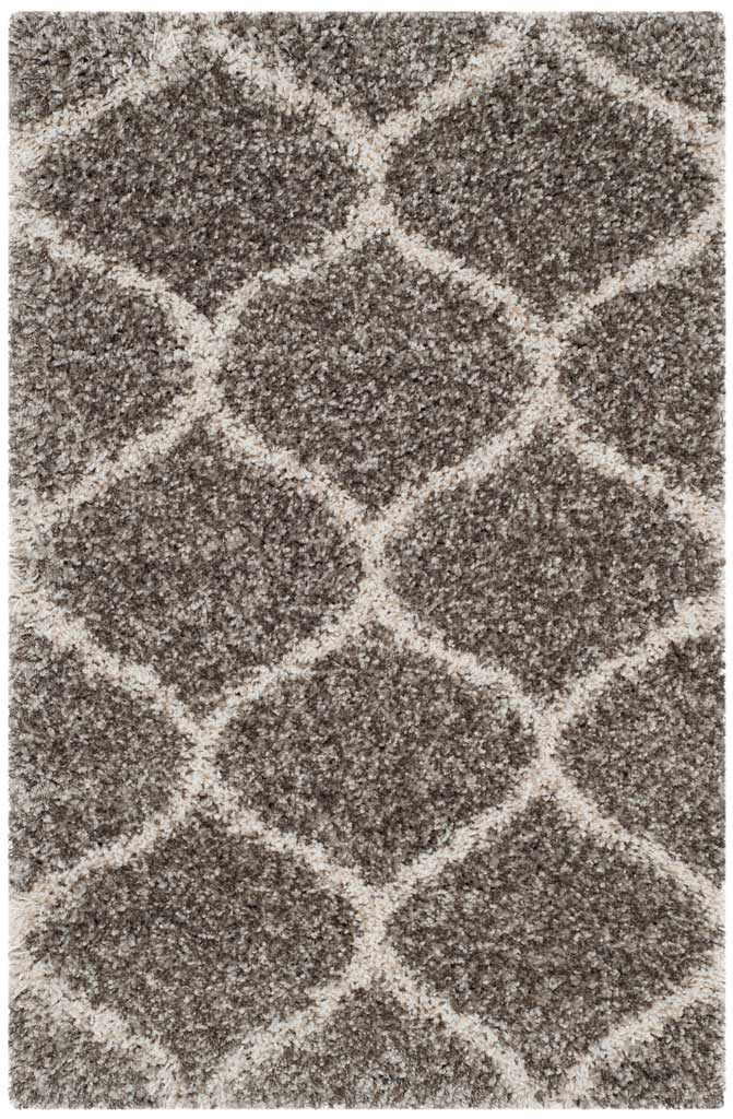Small gray shag accent rug patterned with ivory rounded diamonds