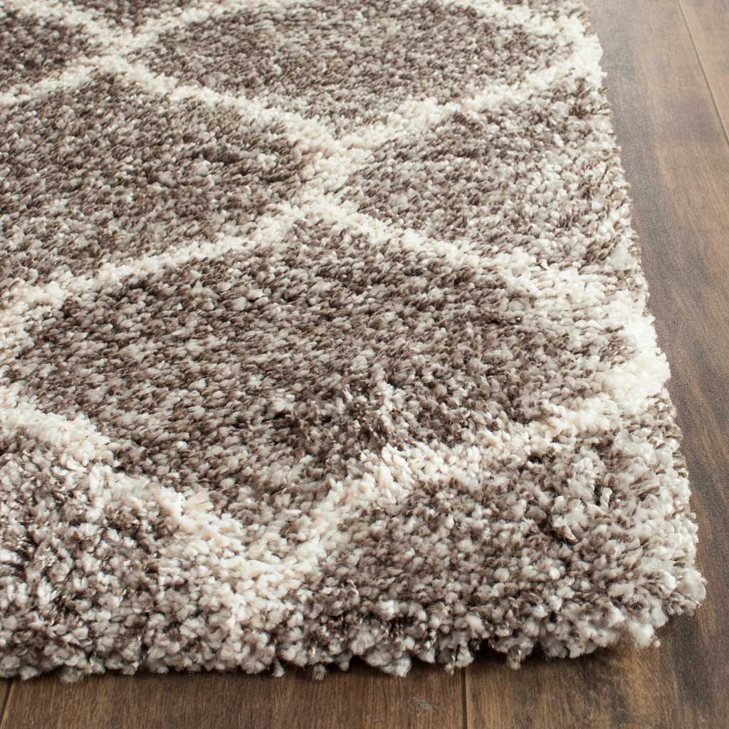 Dense gray fibers and ivory curves finish in a cushioned shag rug corner.