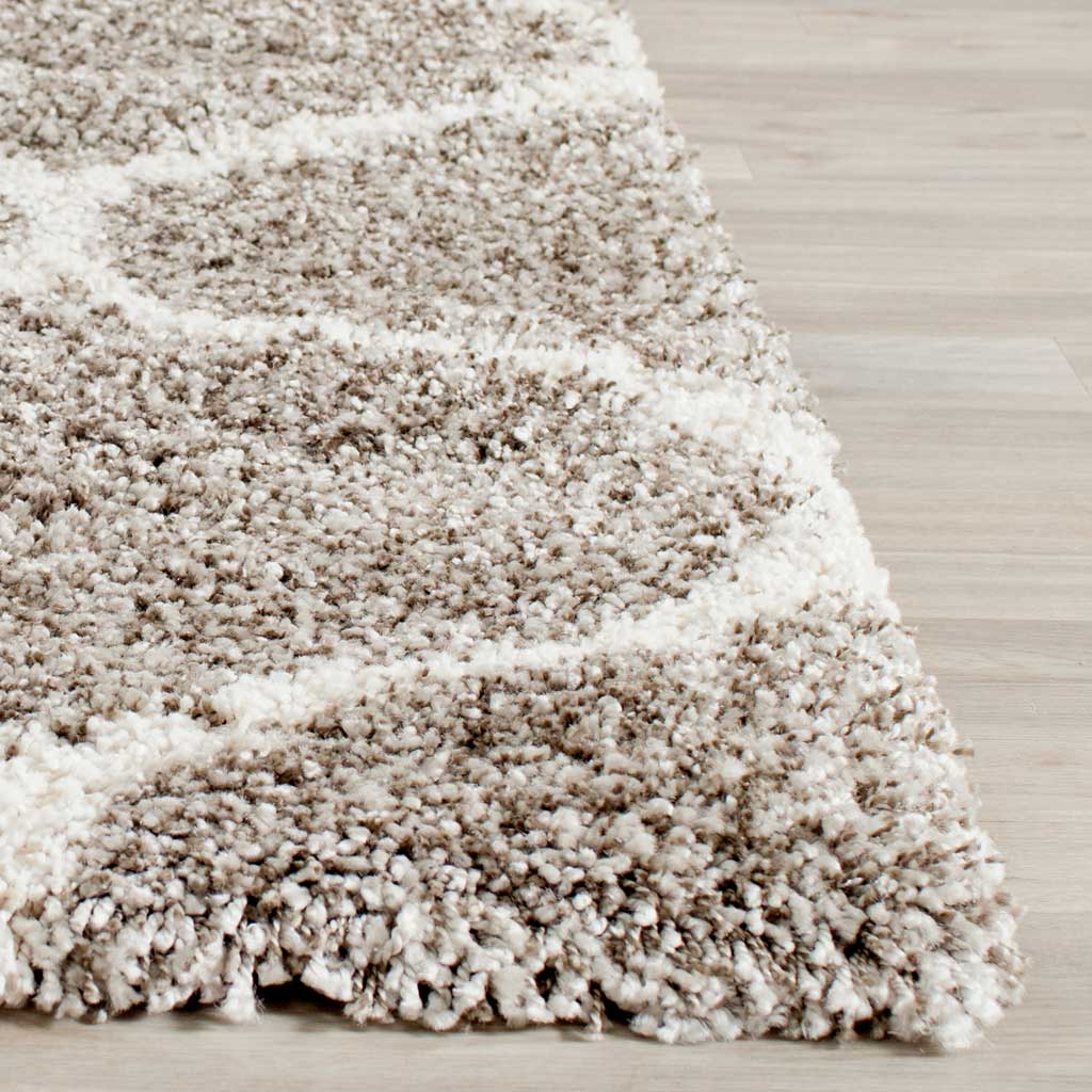 Soft gray pile and ivory curved lines meet at the rug's edge