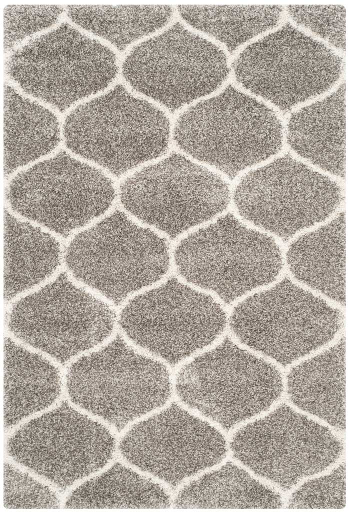 Ivory outlines weave rounded motifs across plush gray pile