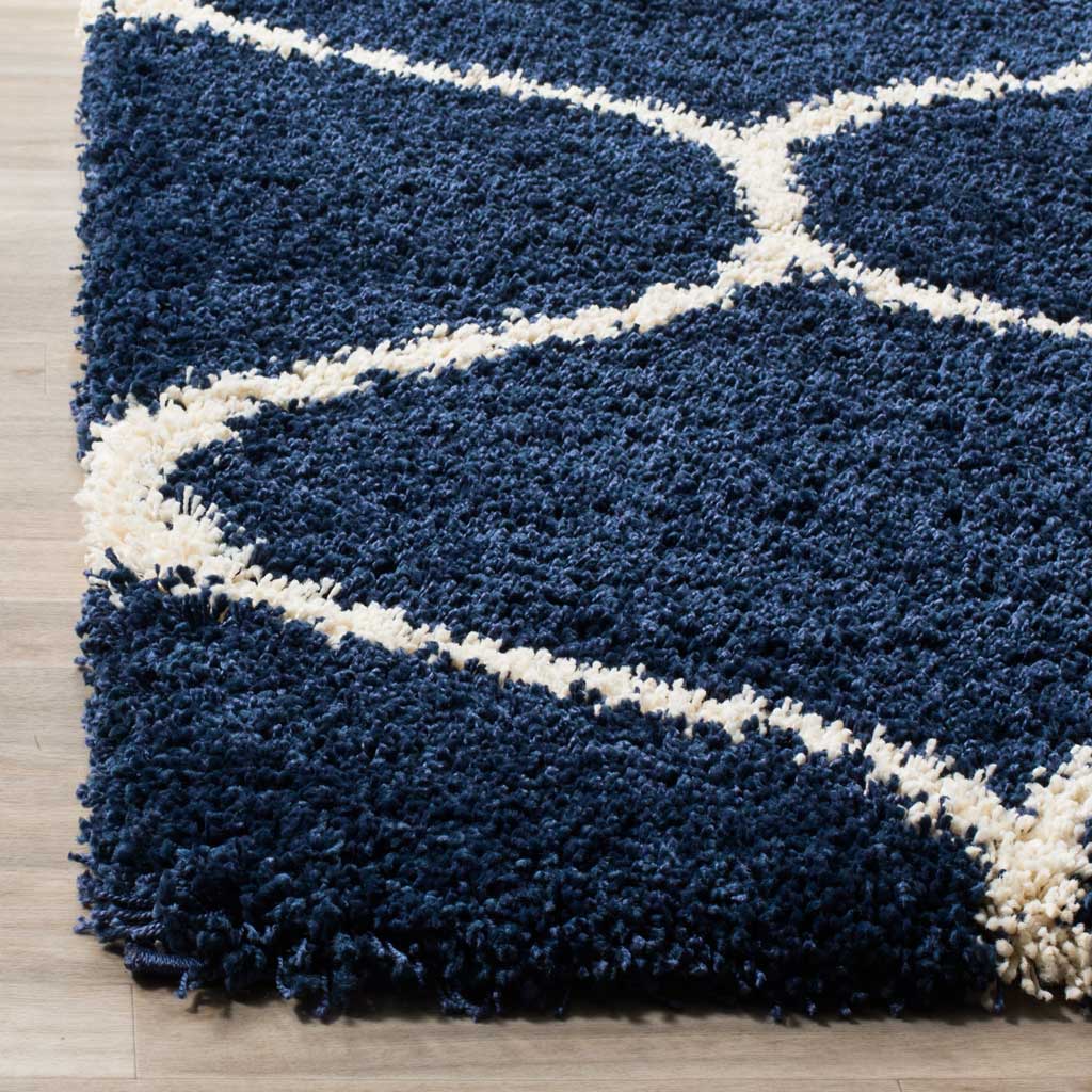 Thick navy fibers frame an ivory curve at the finished edge