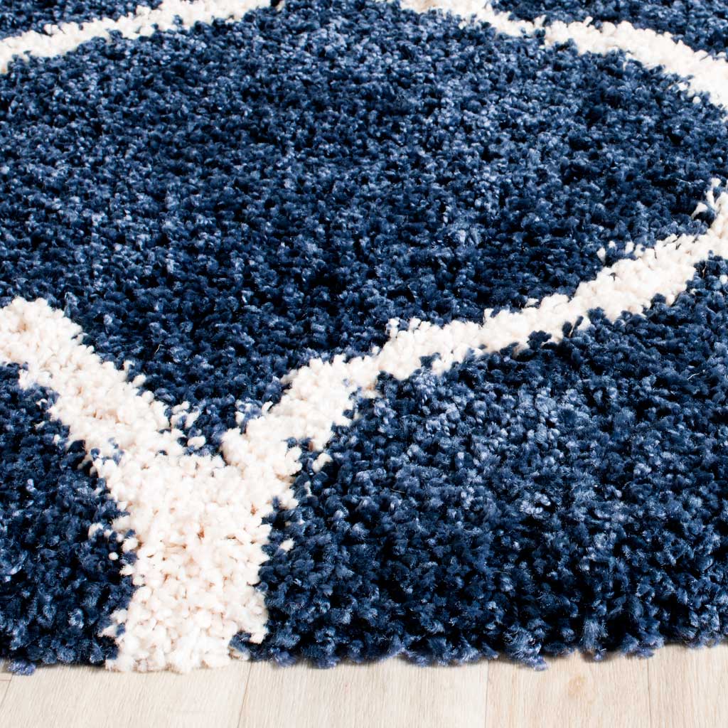 Dense navy shag and raised ivory lines create a plush rug edge