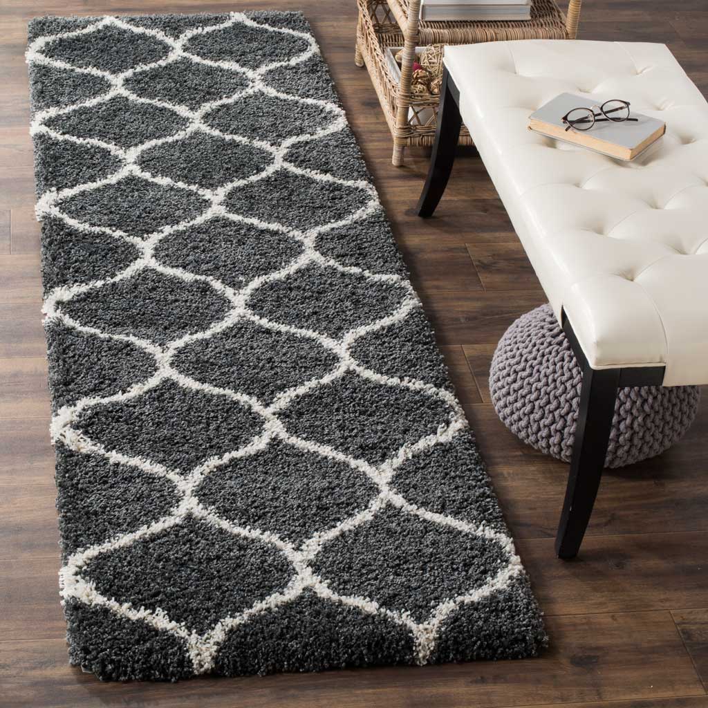 Plush charcoal-gray shag and ivory rounded diamonds add graphic warmth to a room.