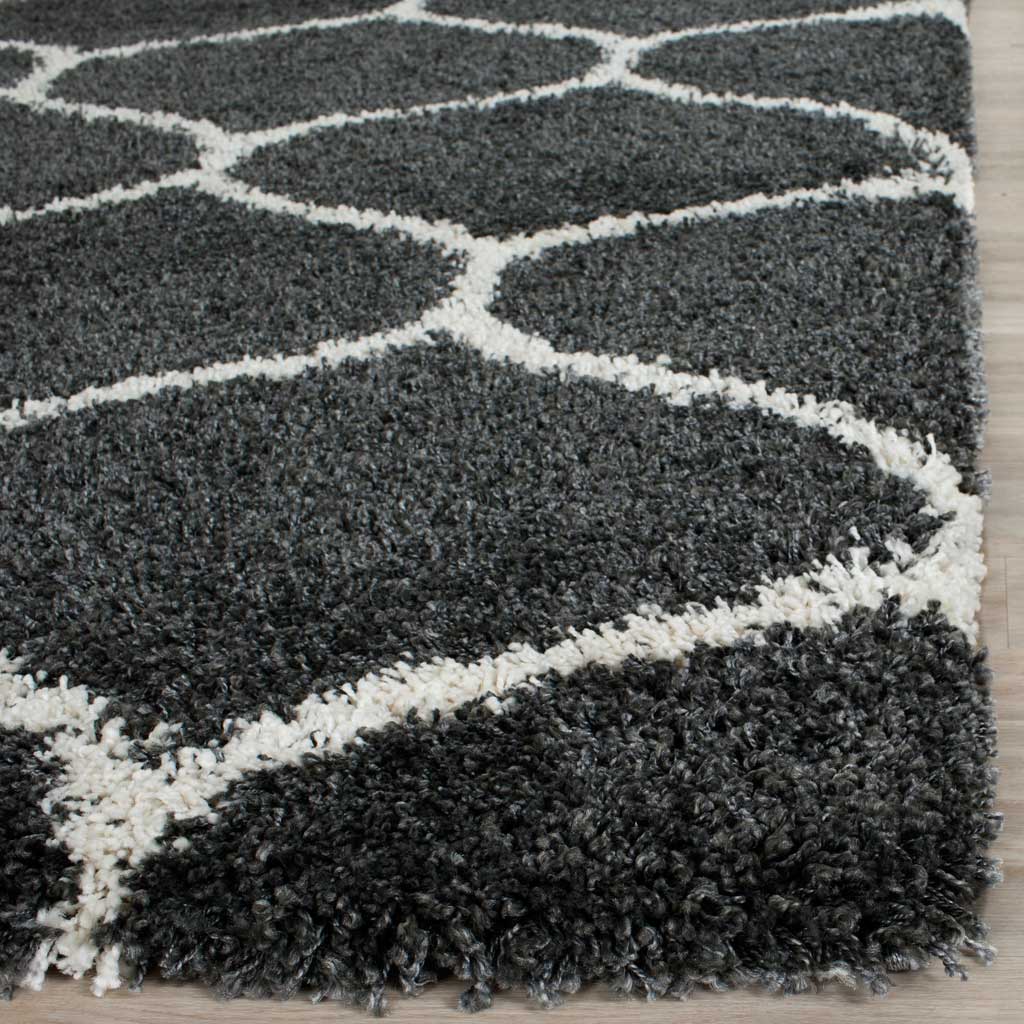 Thick charcoal fibers frame ivory curved lines at the finished edge