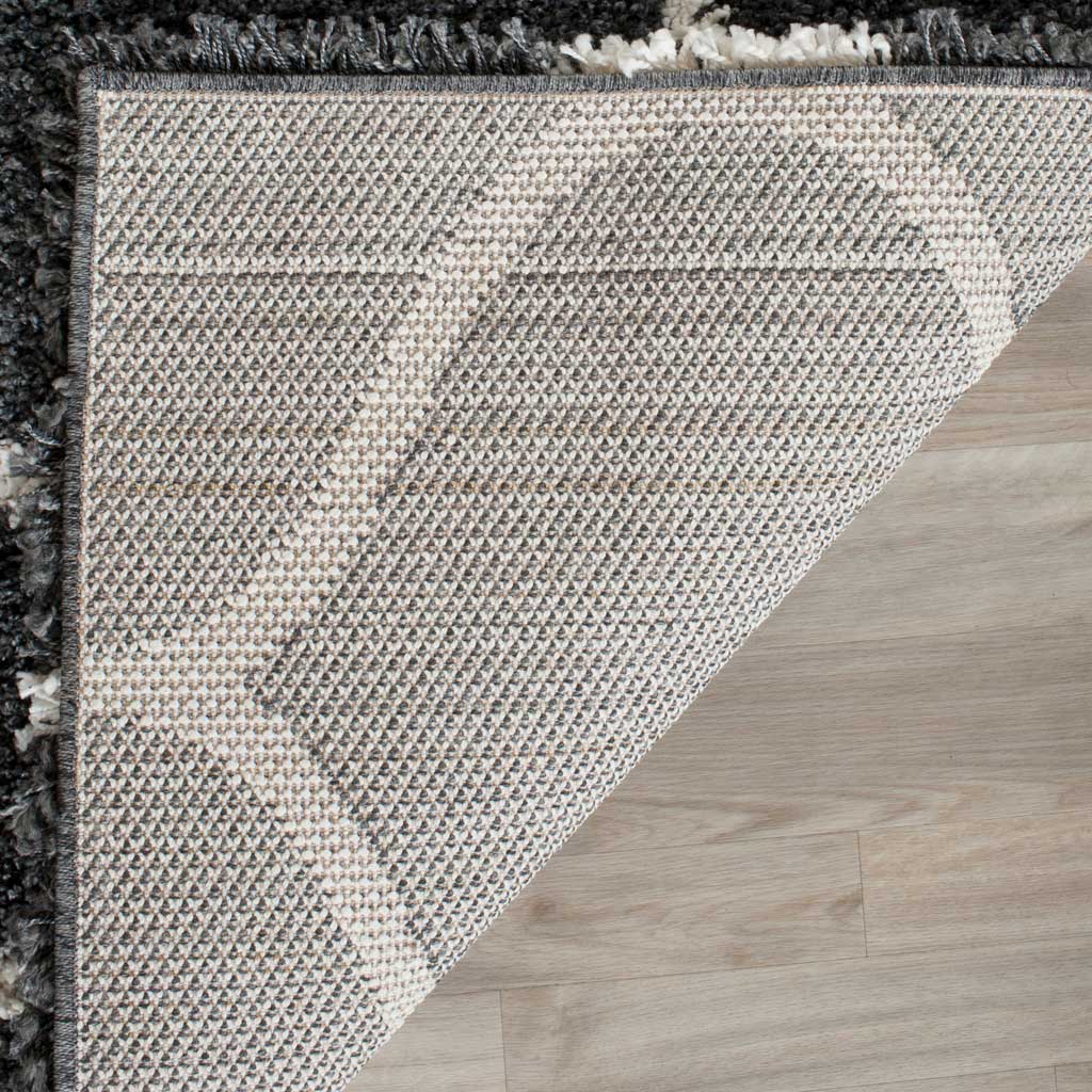 Woven underside supports the dark gray shag and ivory pattern
