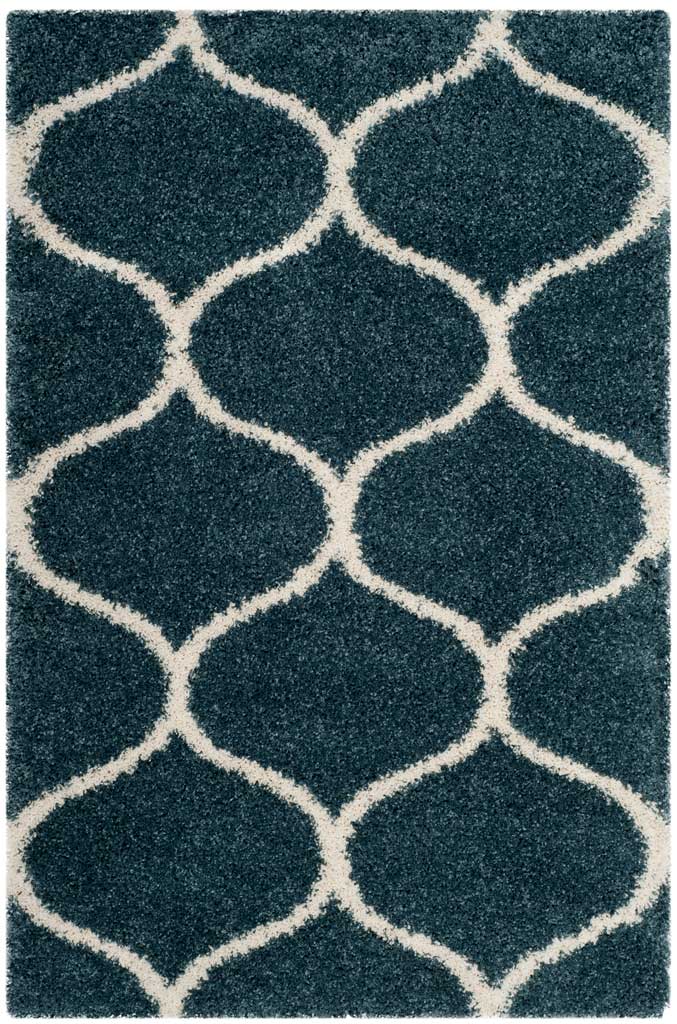 Blue rectangular shag rug with broad ivory curved trellis lines