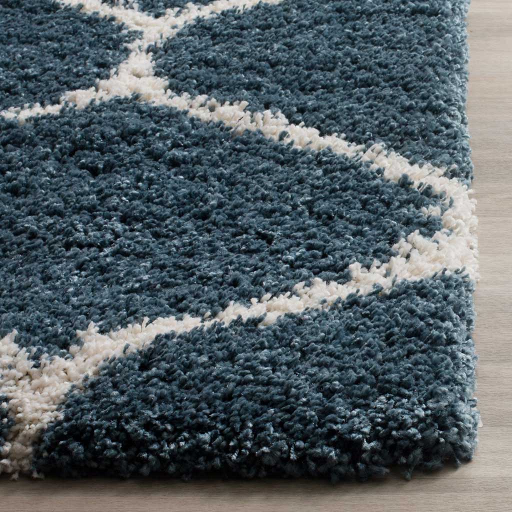 Thick blue fibers and ivory curves meet at a finished rug edge