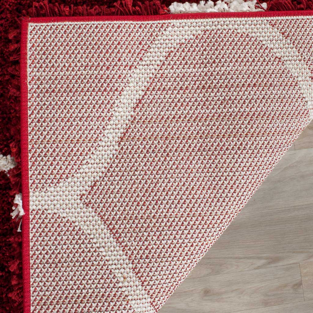 Woven underside and red bound edge support the shag surface