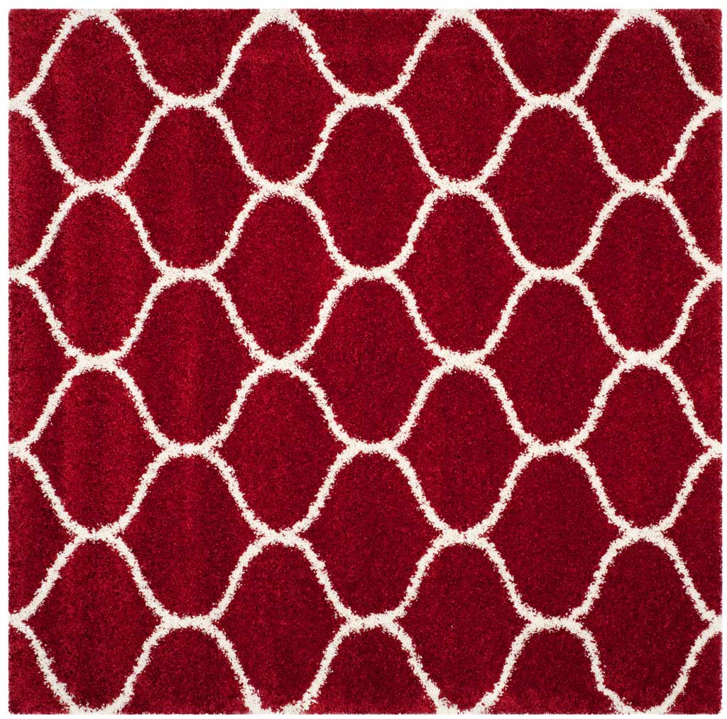 Square red rug patterned with interlocking ivory curved lines