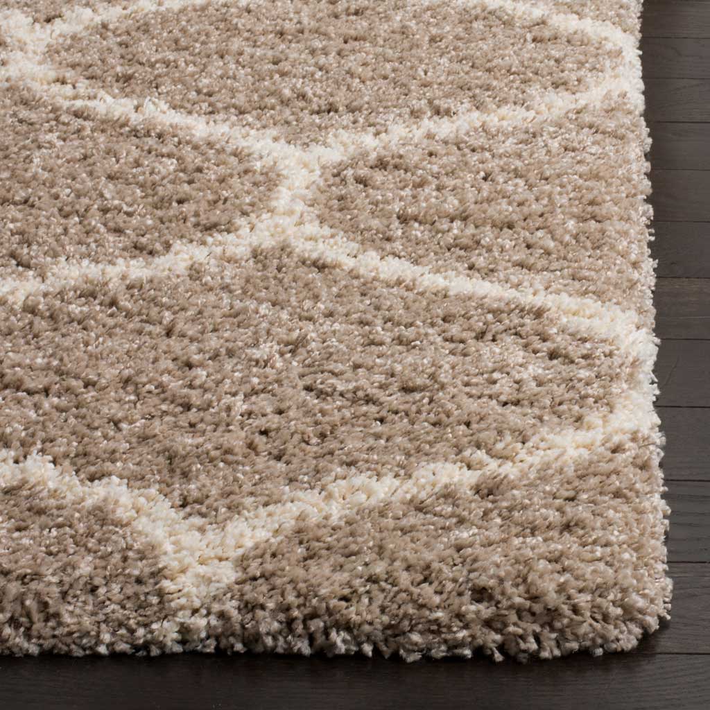 Dense beige fibers meet raised ivory curves along the rug's edge