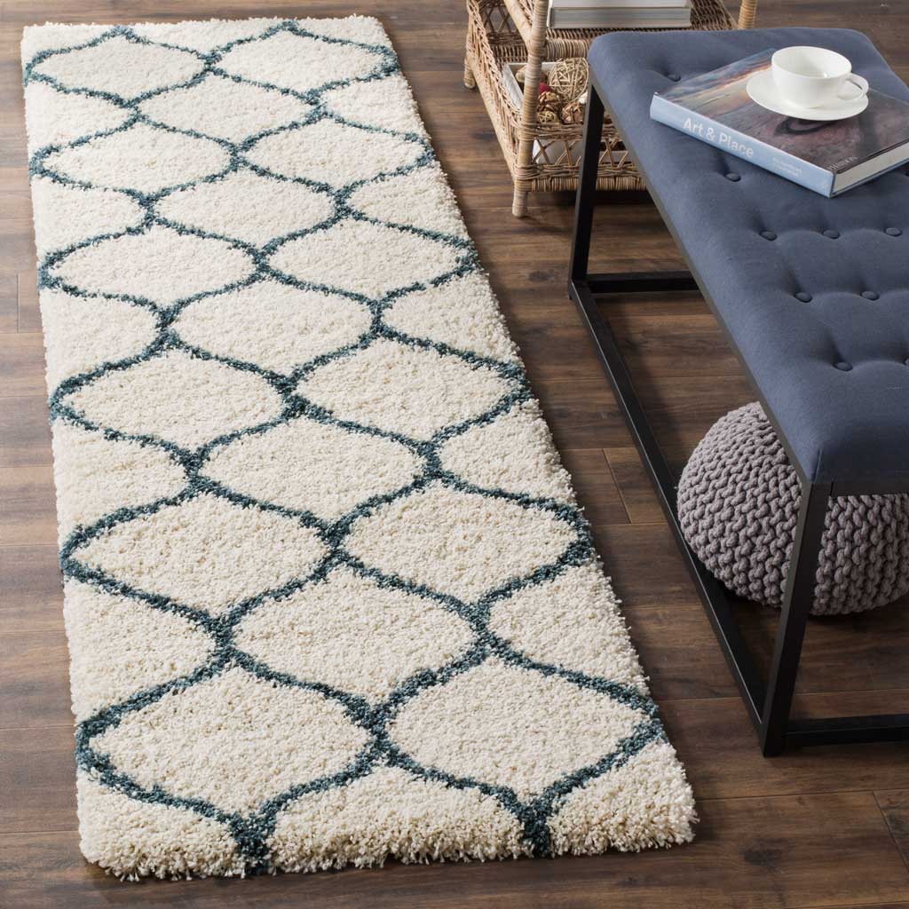 Deep steel blue trellis lines cross an ivory shag surface for crisp contrast.