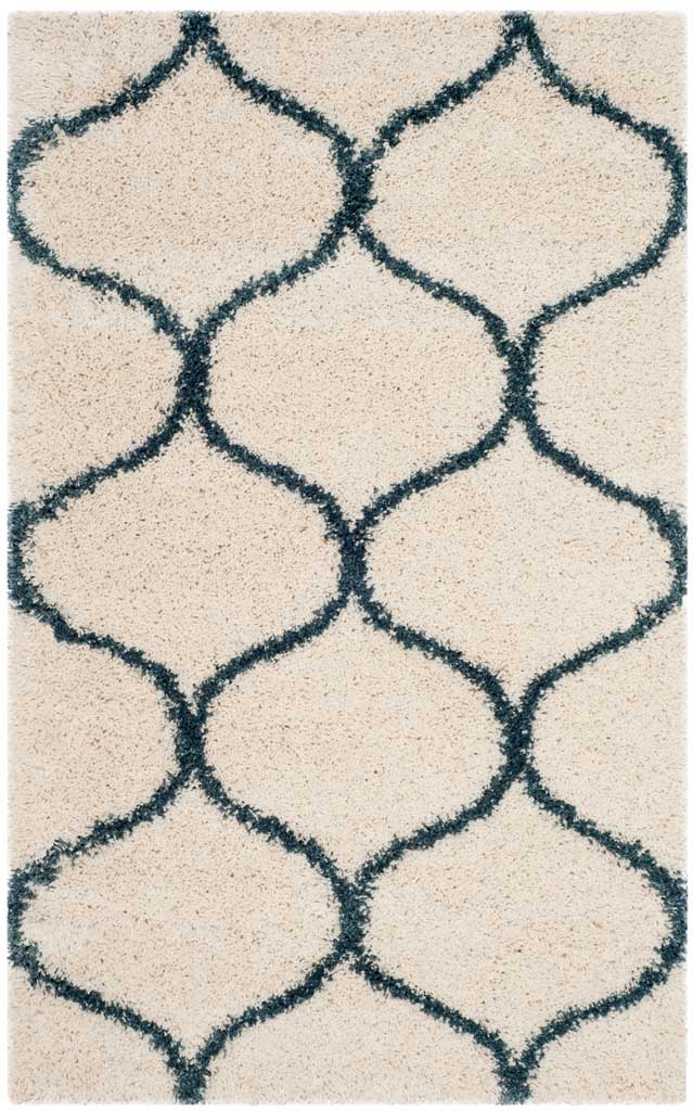 Small ivory shag rug with a bold steel blue curved trellis