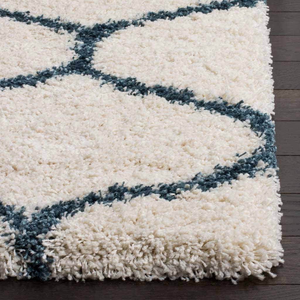 Thick ivory pile meets steel blue lines along a soft finished edge