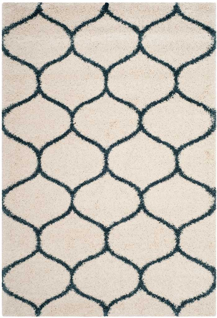 Steel blue contours form rounded motifs on soft ivory shag