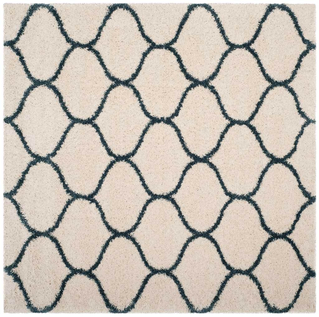 Square ivory rug covered in interlocking blue curved lines