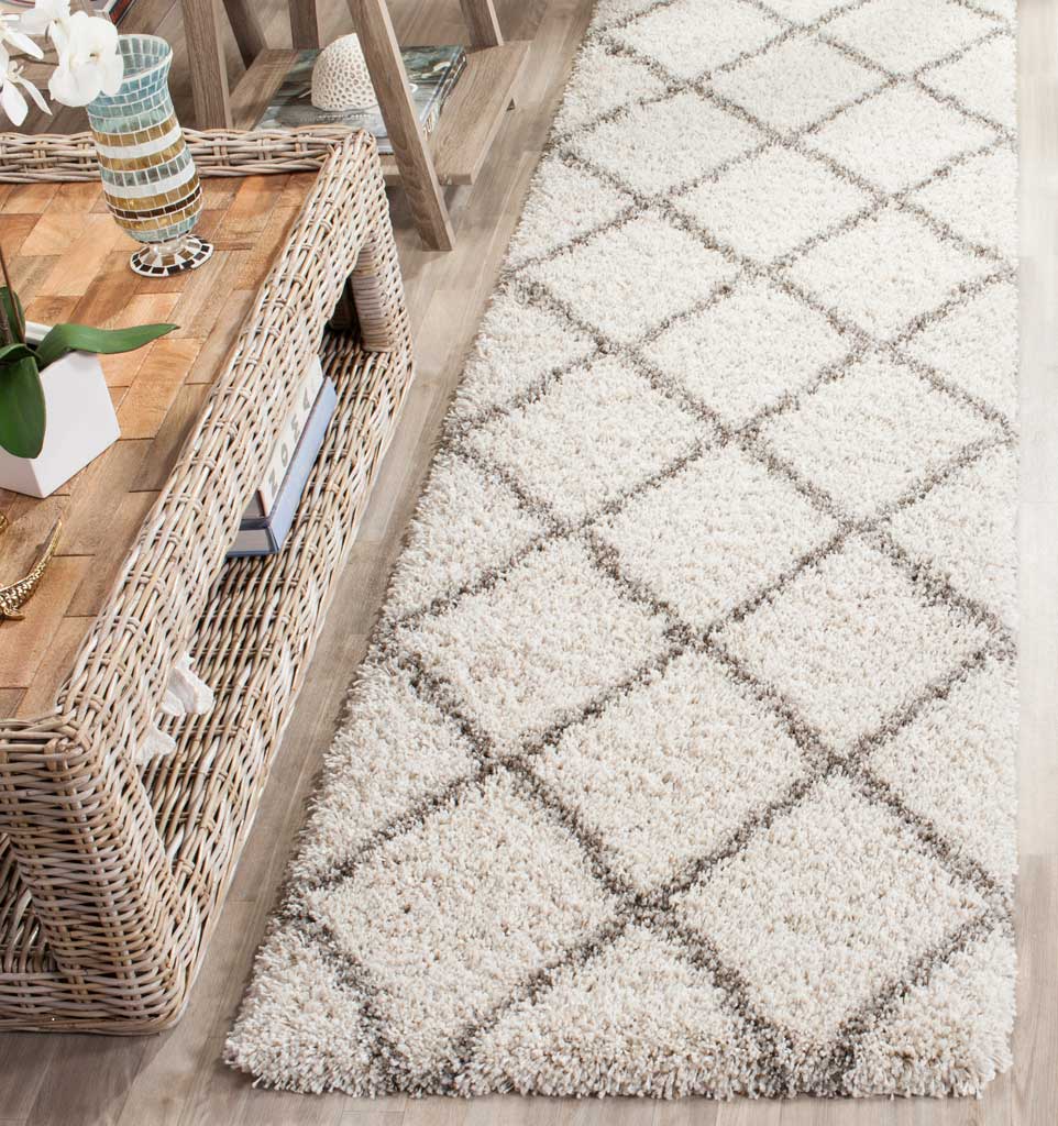 Plush ivory fibers and gray geometric accents soften a narrow walkway.