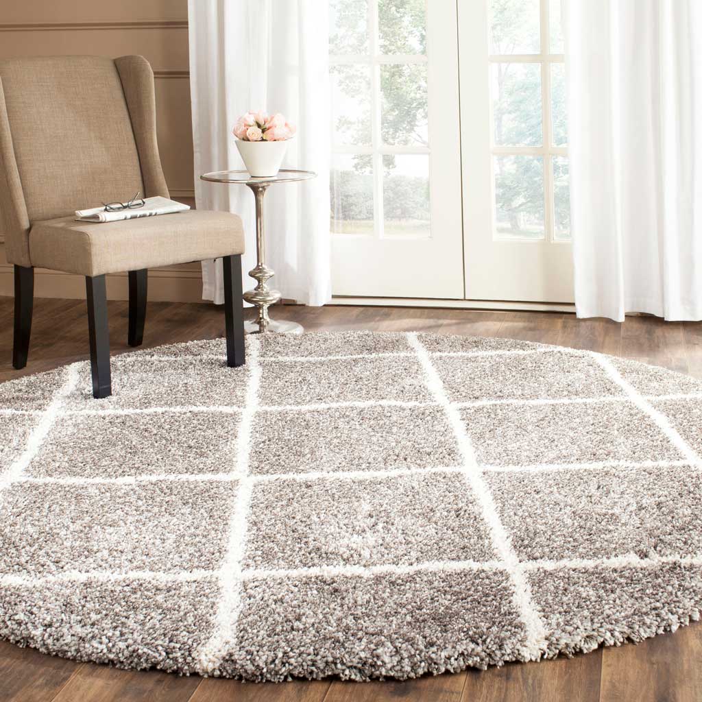 A mottled gray pile and ivory trellis give this circular rug a warm, layered look