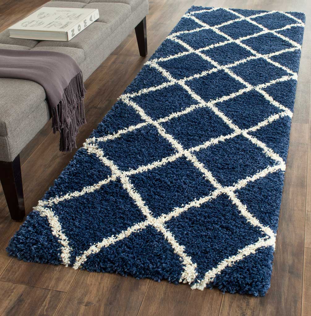 Deep navy and ivory geometric trellis lends bold contrast and warmth to the floor.