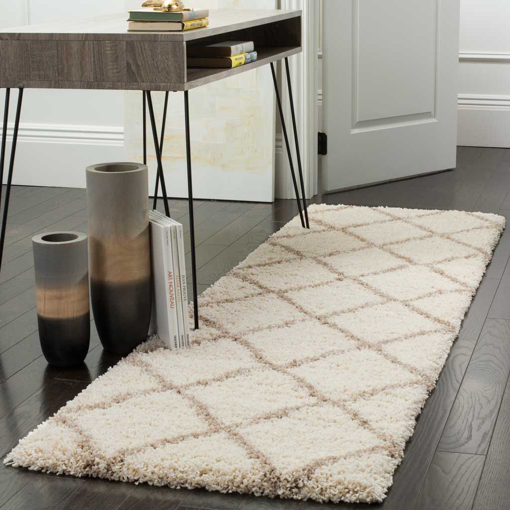 Creamy ivory pile and delicate beige trellis lines lend warmth to a hallway.