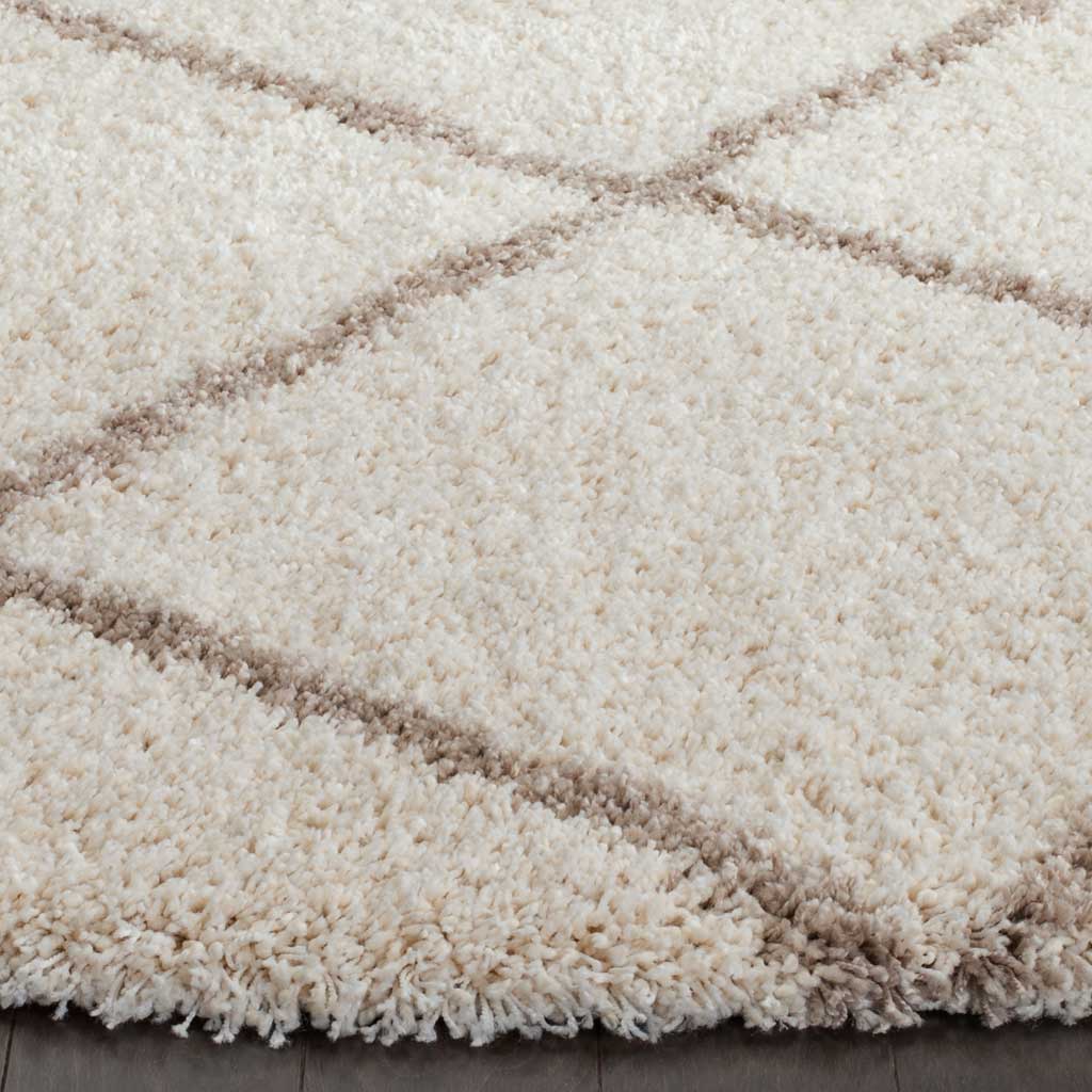 Thick ivory shag is traced with warm beige lines at its cozy, textured edge