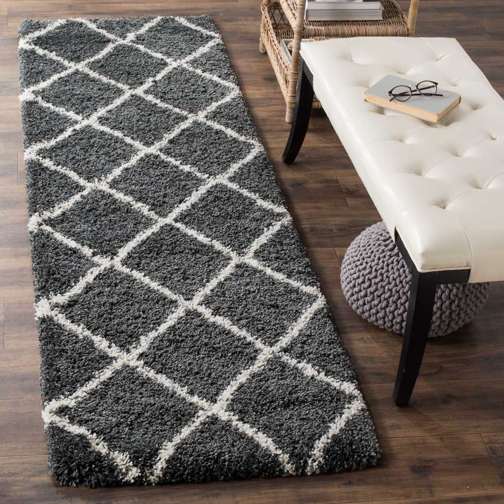 A plush dark gray pile and ivory lattice create cozy contrast underfoot.