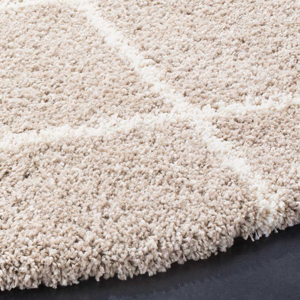 Dense beige fibers meet ivory lines along the soft, thick rug edge