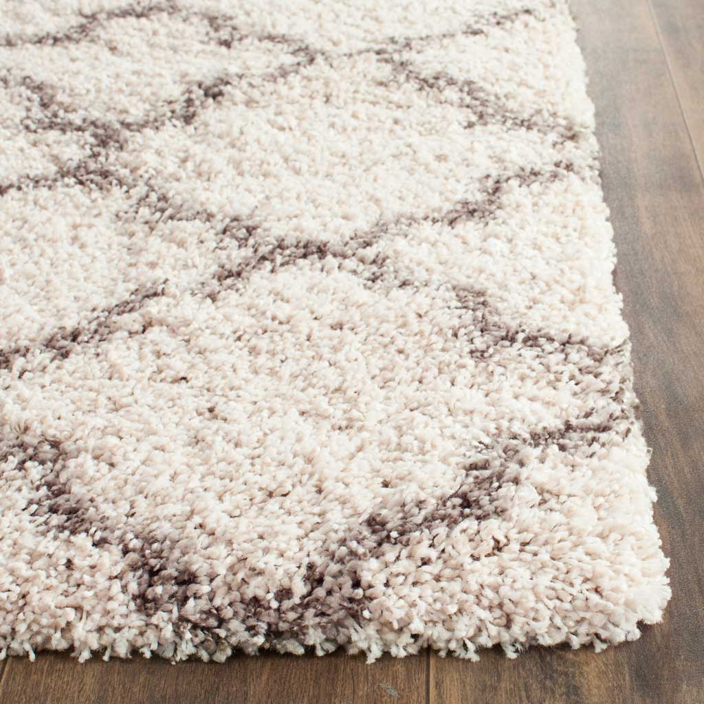 Ivory shag fibers and gray curved lines meet at a deep, fluffy corner.