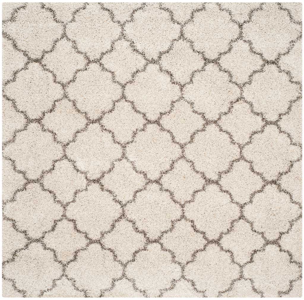 Square ivory rug patterned with repeating gray quatrefoils