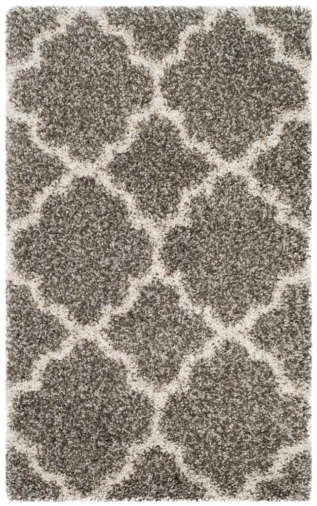 Gray accent rug with a bold ivory quatrefoil pattern